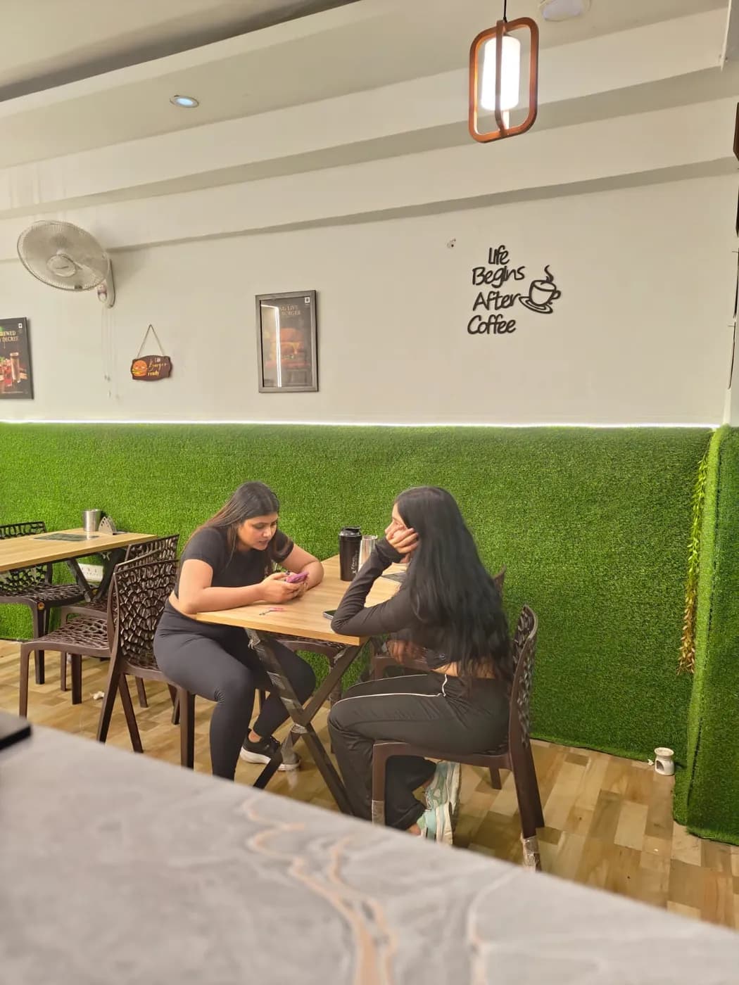 Green wall seating and cafe ambience at Burger Minister, Sector 58 Noida