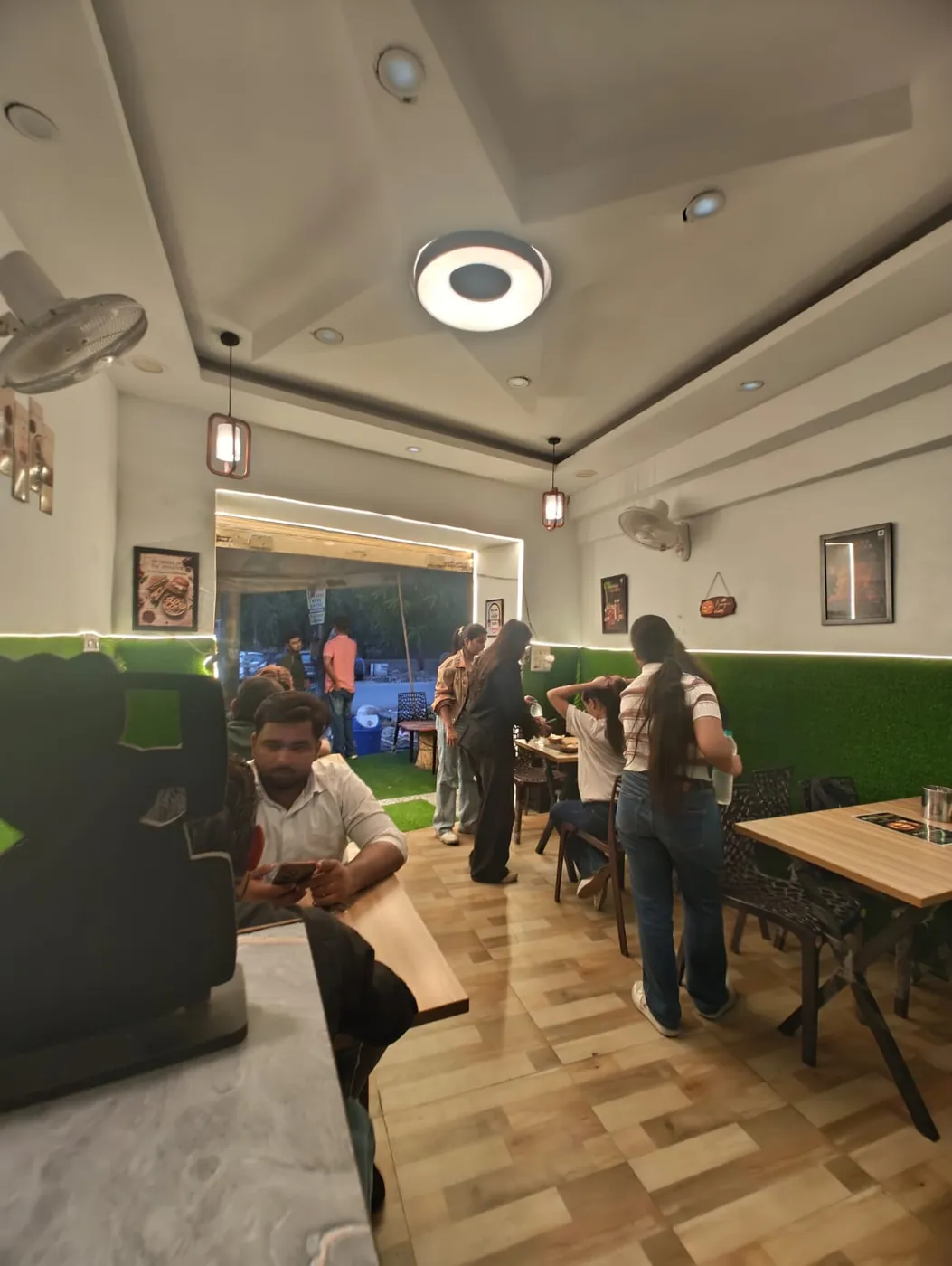 Busy dine-in seating at Burger Minister pure veg cafe, Sector 58 Noida